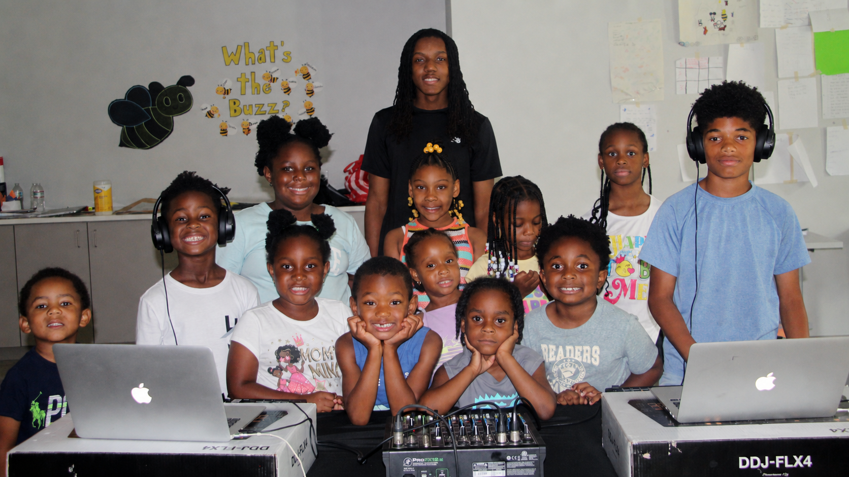 Future of Music students gathered around DJ equipment