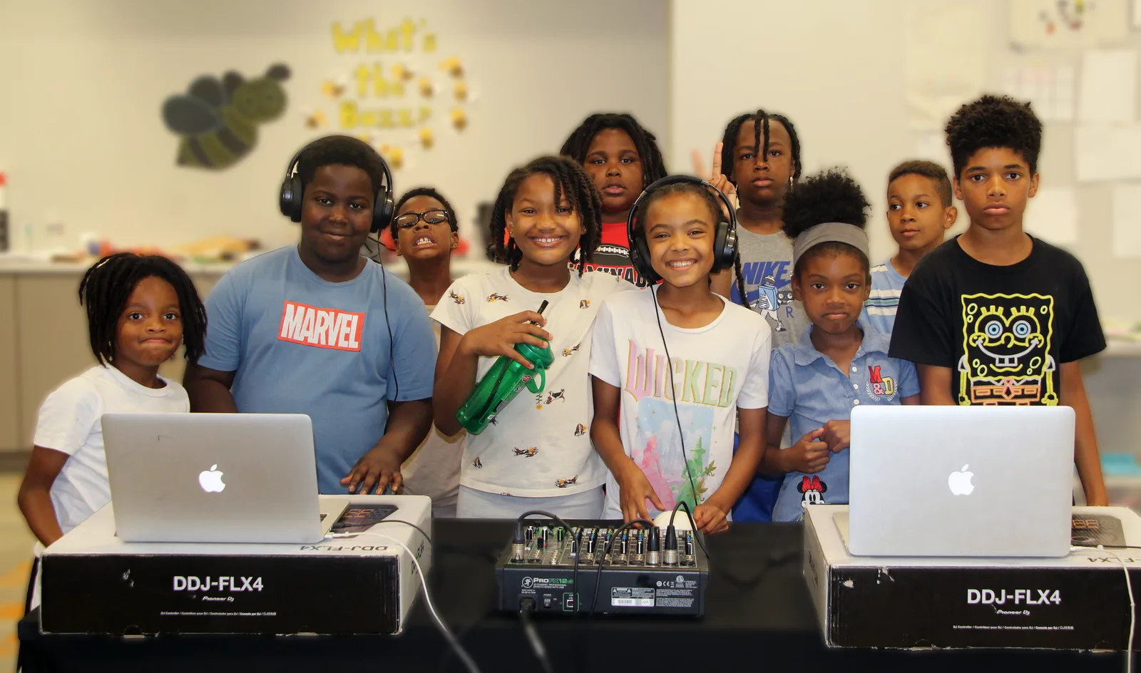 Future of Music students together with headphones, laptops, and DJ equipment